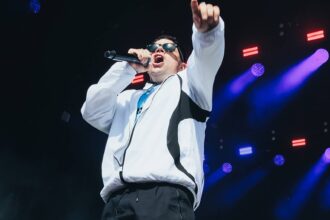 Kneecap. 's Móglaí Bap performs at Glastonbury 2025. Andy Ford for NME
