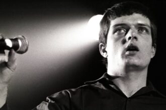 Joy Division. 's Ian Curtis performing live in 1980. Rob Verhorst/Redferns/Getty